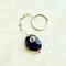 Handmade Amethyst keychain with deep purple stone, silver wire wrap, and infinity loop chain shown on neutral white leather background.